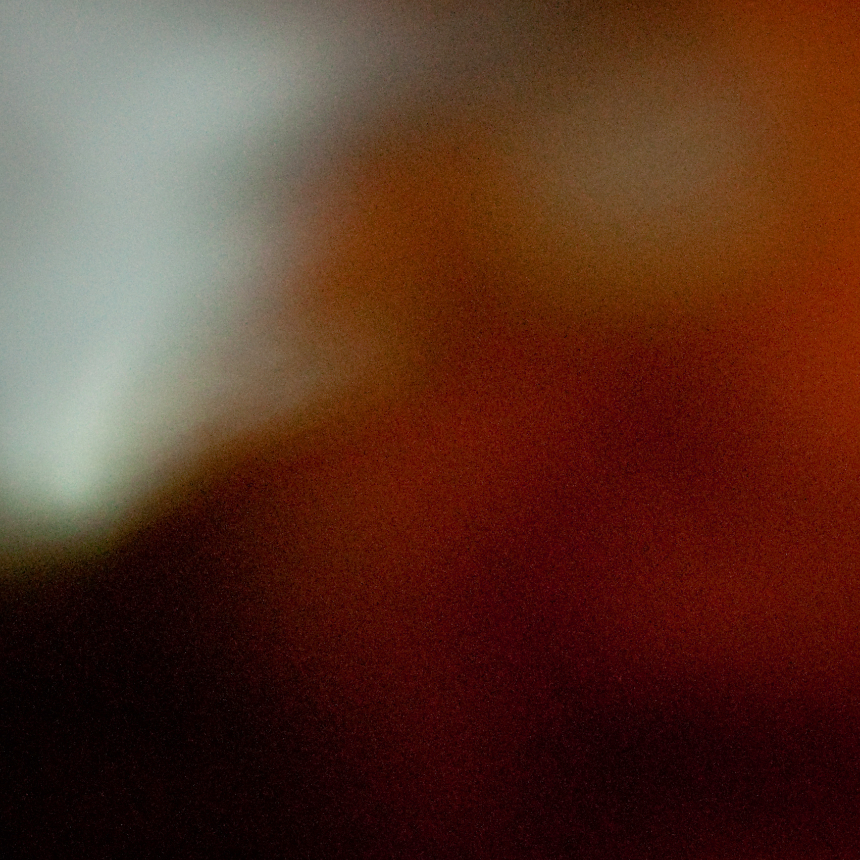 An abstract, blurry photo with some grainy red and blue