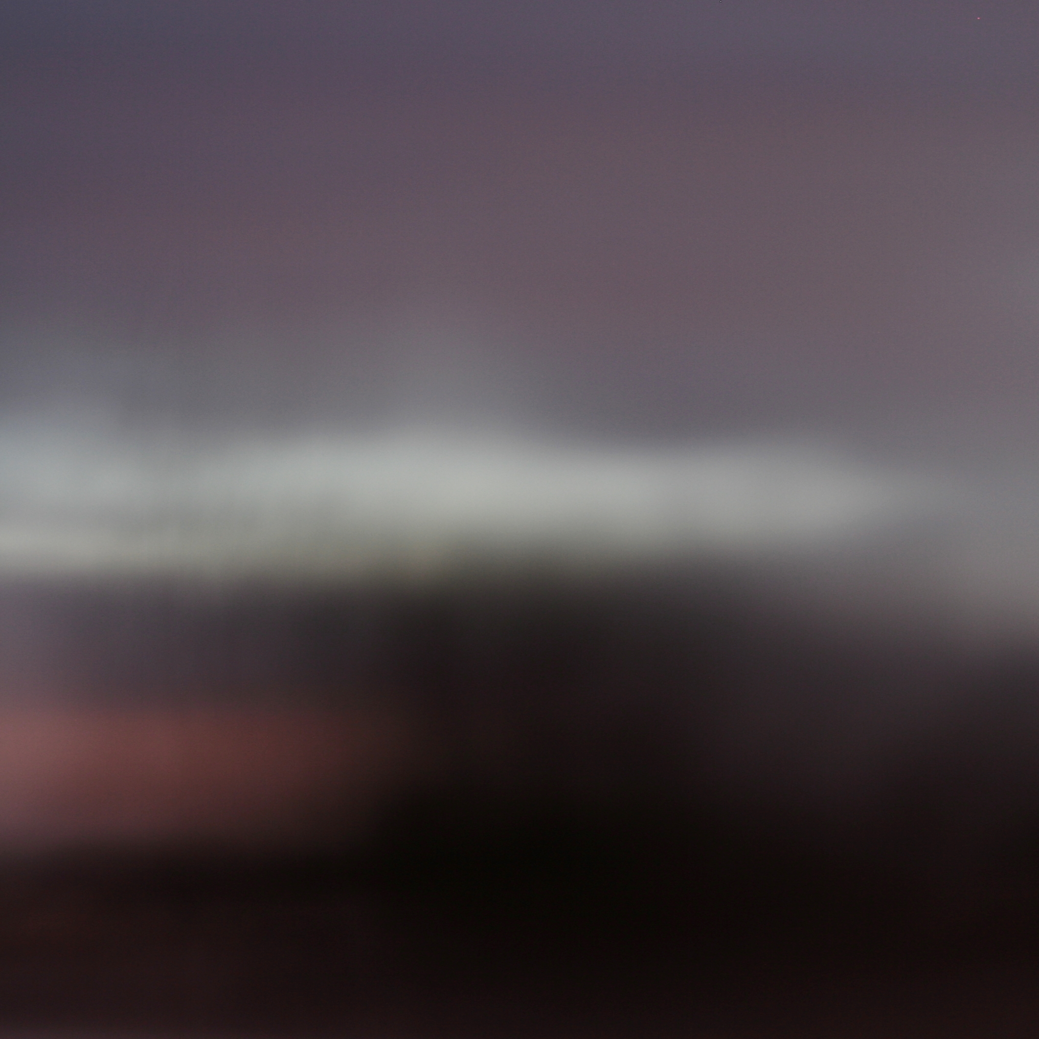 The fourth abstract, blurry photo, with some blue and pink areas.